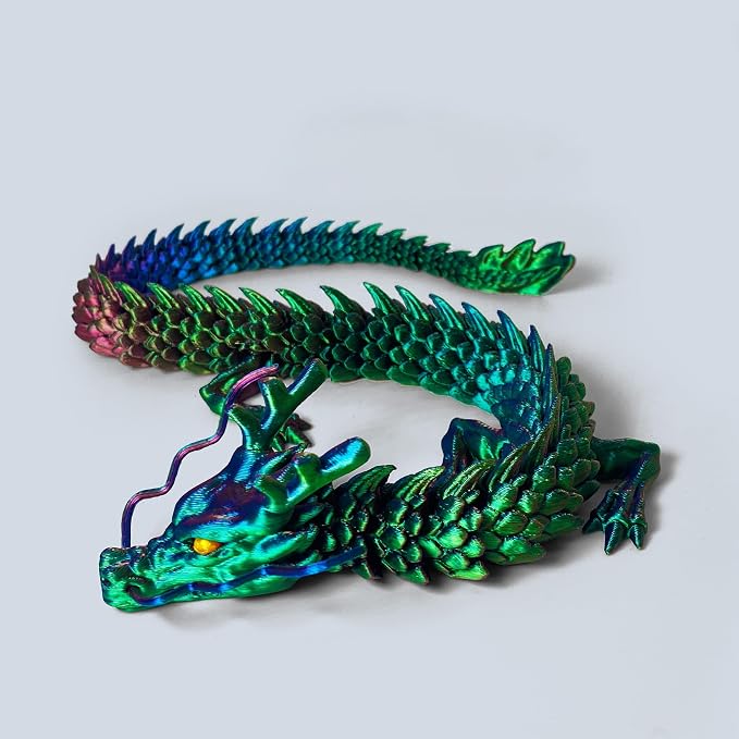 Holographic green and blue articulated dragon figure, curled in a resting pose.